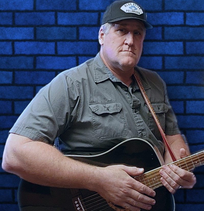 Scott DuBose, front man of Hurricane, holding an acoustic guitar